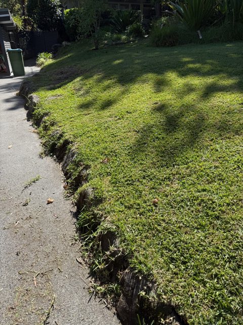 Lawn trimmed neatly over a sandstone edge