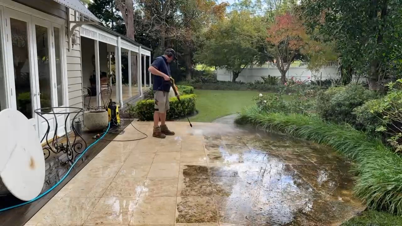 Pressure washing a sandstone patio back to its original colour